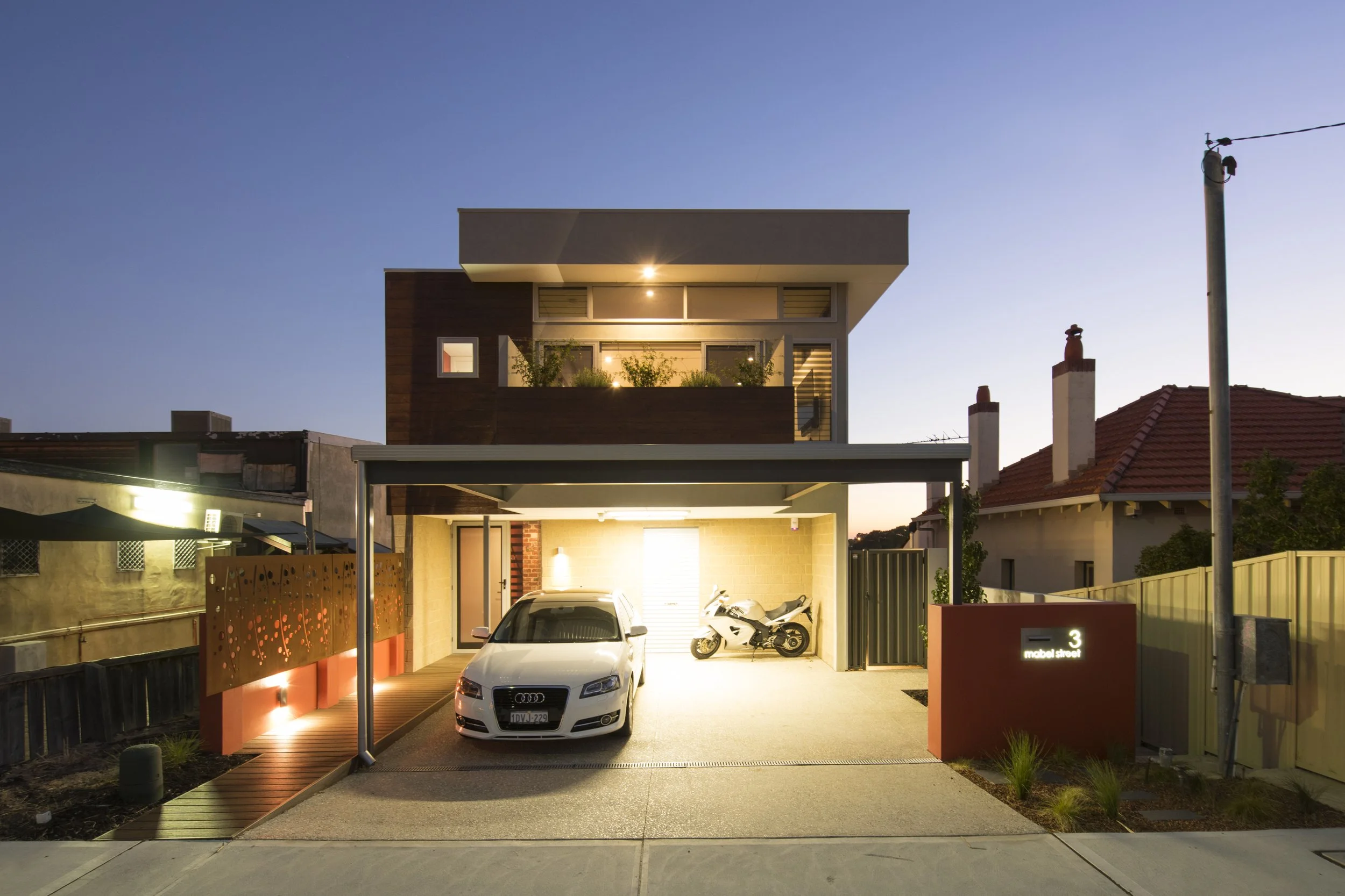 A modern two-storey Perth home on a landscaped streetscape at dusk